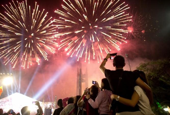 People look at fireworks during a New Year Celebration in Manila on January 1, 2015. Philippines New Year