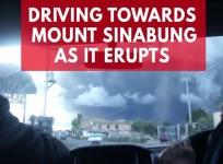 Mount Sinabungs massive eruption seen from vehicle approaching the spewing spectacle