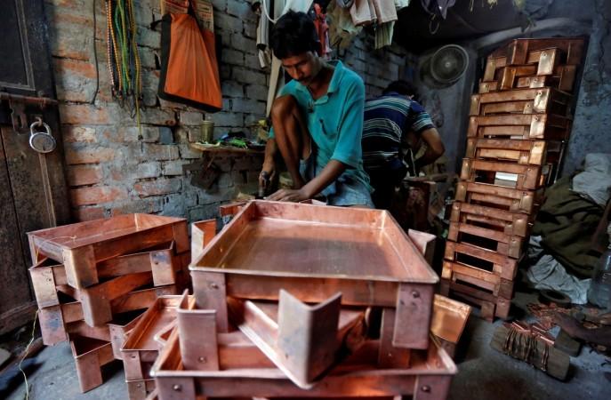 A worker makes copper trays inside a workshop in Kolkata, India, October 26, 2017. worker