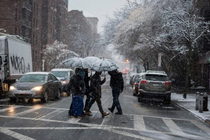 People make their way during a snowstorm in New York US snow