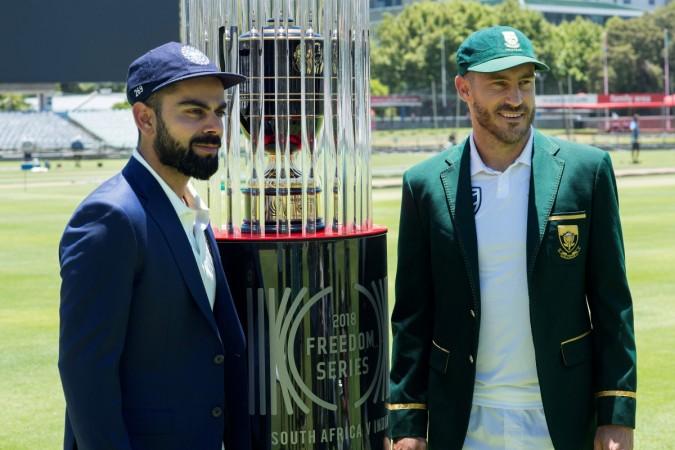 India's captain Virat Kohli (left) and South Africa's skipper Faf du Plessis pose with the 2018 Freedom Series trophy, at the Newlands Cricket ground on January 3, 2018, in Cape Town, prior to the first Test. Virat Kohli Faf du Plessis