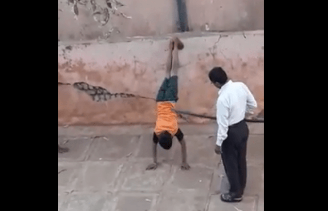 The warden was caught thrashing the two school children for not attending classes regularly warden caught beating two school children
