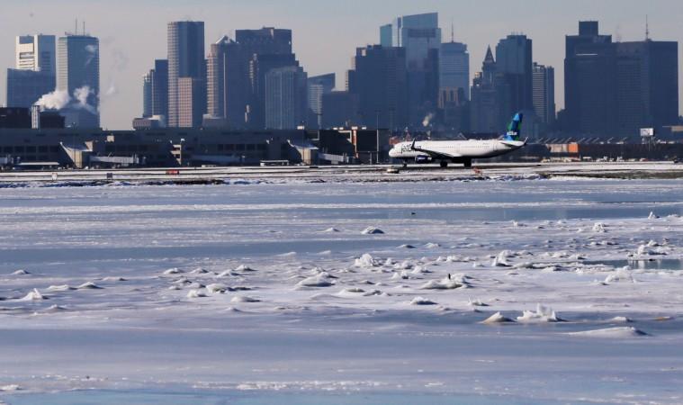 Ahead of an incoming winter snow storm, a Jet Blue flight waits to take off from Logan International Airport next to the frozen waters of the Atlantic Ocean harbour between Winthrop and Boston, Massachusetts, U.S., January 3, 2018. Logan International Airport next to the frozen waters of the Atlantic Ocean harbour