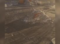 Black snow covers a playground in Kazakhstan