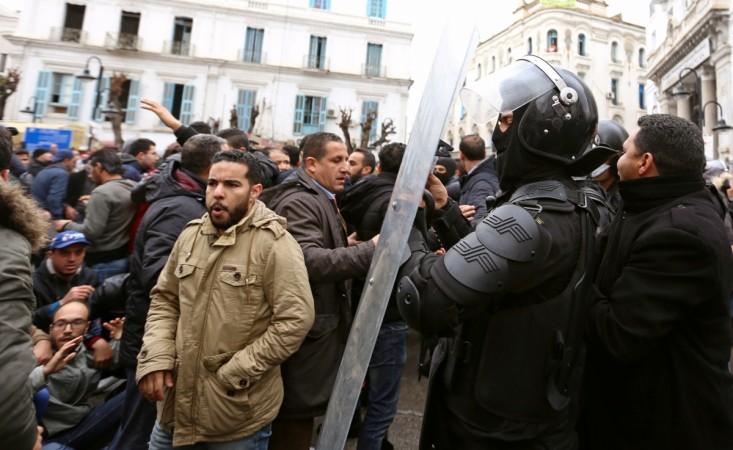 Tunisian protesters clash with riot police during demonstrations against rising prices and tax increases, in Tunis, Tunisia. tunisia protest