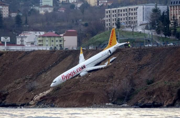 A Pegasus Airlines Boeing 737 passenger plane is seen struck in mud on an embankment, a day after skidding off the airstrip, after landing at Trabzon's airport on the Black Sea coast on January 14, 2018 Pegasus Airlines