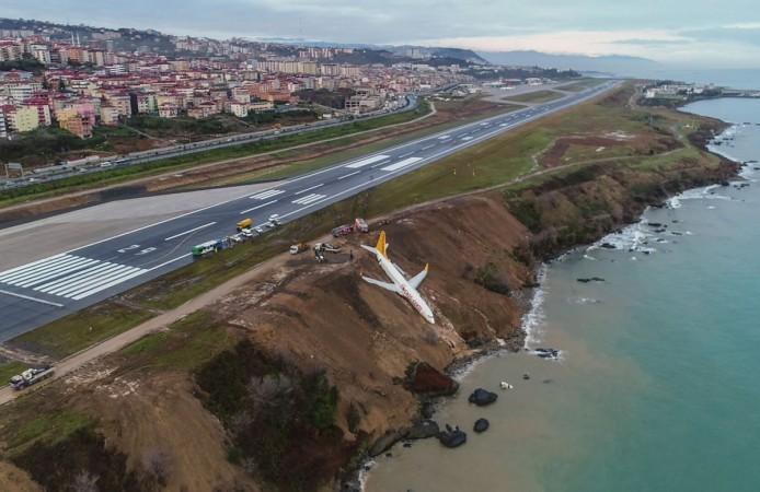 A Pegasus Airlines Boeing 737 passenger plane is seen struck in mud on an embankment. Pegasus Airlines