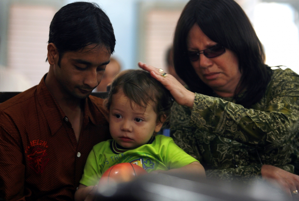 Two-year-old Moshe Holtzberg is held by his grandmother Yehudit Rosenberg and domestic help Jackie during a condolence prayer meeting in a synagogue, for those killed by armed militants at a Jewish centre in 'Nariman House' in Mumbai December 1, 2008. baby moshe