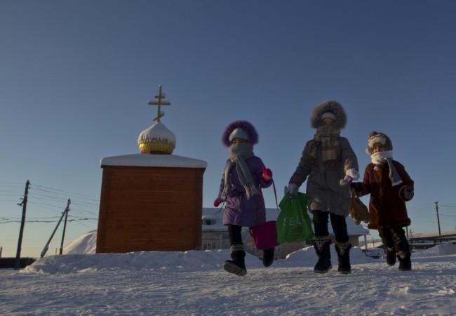 The children are seen going outside in Oymyakon when it is not freezing cold. siberia cold town