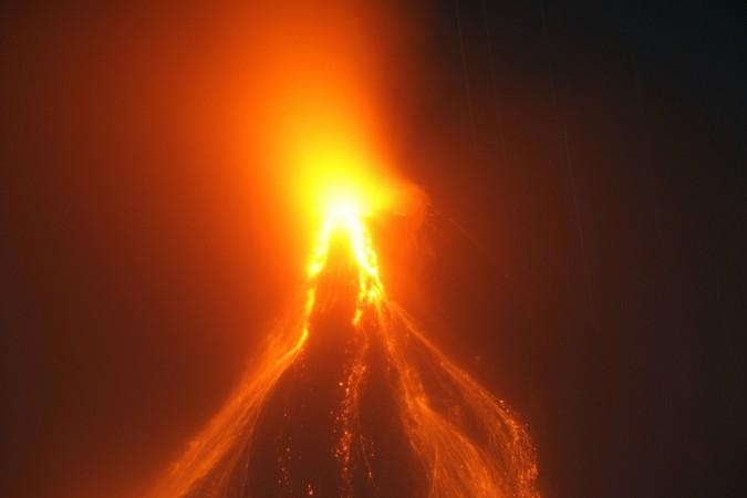 Glowing lava continues to cascade further down the slopes of the Mayon volcano in Cagsawa town, Albay province, south of Manila December 27, 2009. Mount Mayon