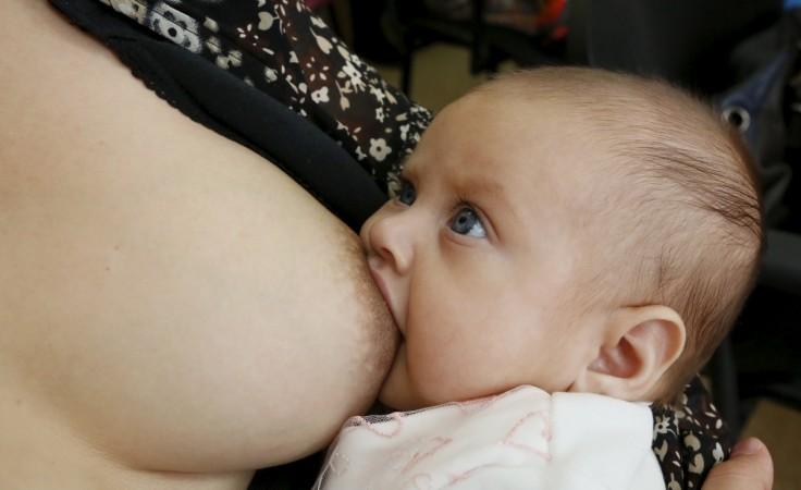 A mother breastfeeds her child together with other women during a flash mob at a children's polyclinic in the Siberian city of Krasnoyarsk, Russia. Breastfeeding