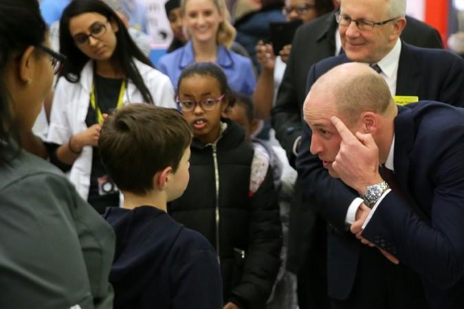 Prince William, Duke of Cambridge (R) points to an old scar as he meets a young patient during a visit to Evelina London Children's Hospital, in London on January 18, 2018 Prince William