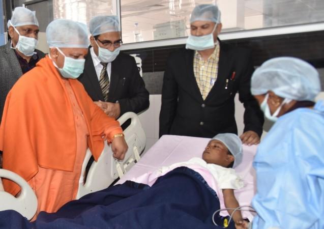 Uttar Pradesh Chief Minister Yogi Adityanath visits the child, who is admitted to KGMU trauma centre after being attacked by his schoolmate -a girl- with a knife two days ago to ensure that the school closed early, in Lucknow on Jan 18, 2018. lucknow student attacked