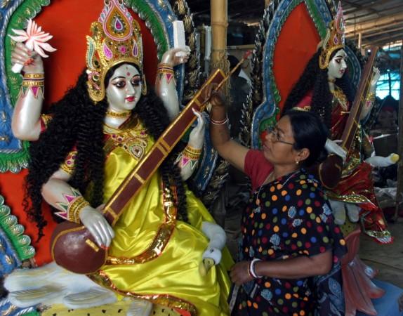 An artist applies finishing touches on an idol of Saraswati, the Hindu goddess of education, ahead of Saraswati Puja festival in the north-eastern Indian city of Chandigarh January 21, 2007. Saraswati Puja