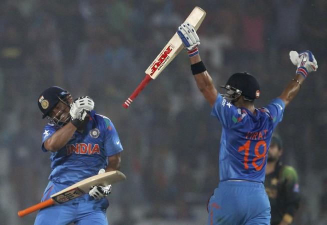 Virat Kohli (right) and Suresh Raina celebrate their victory against Pakistan after their ICC World Twenty20 match at the Sher-E-Bangla National Cricket Stadium in Dhaka March 21, 2014. Virat Kohli Suresh Raina