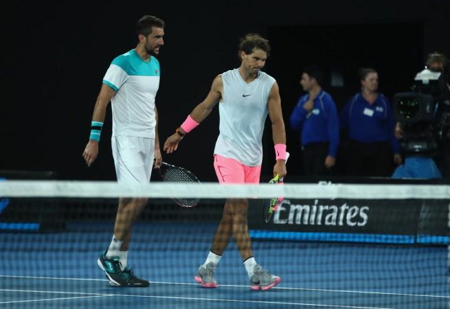 Rafael Nadal of Spain walks off the court after shaking hands because of retiring injured during the fifth set in his quarter-final match against Marin Cilic of Croatia on day nine of the 2018 Australian Open at Melbourne Park on January 23 rafael nadal