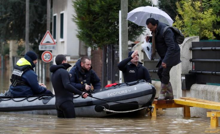 Paris police divers use a small boat to help a resident to leave home as they patrol a flooded street of a residential area in Villeneuve-Saint-Georges, near Paris. Paris flood