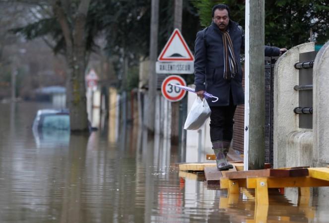A resident leaves home in a flooded street of a residential area in Villeneuve-Saint-Georges, Paris. Paris flood