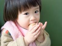 Baby eating egg