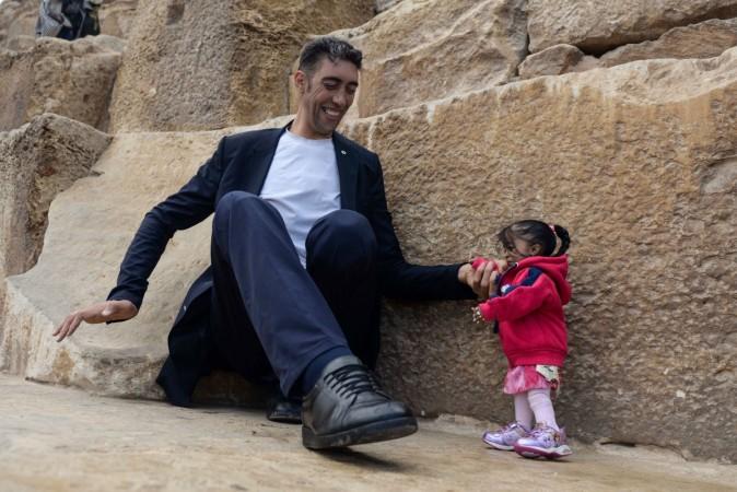 India's Jyoti Amge (R), the world's shortest woman poses for a picture with Sultan Kosen of Turkey, the world's tallest man, at the foot of one of the three Pyramids of Giza in Egypt on January 26, 2018. world's smallest woman and world's tallest man
