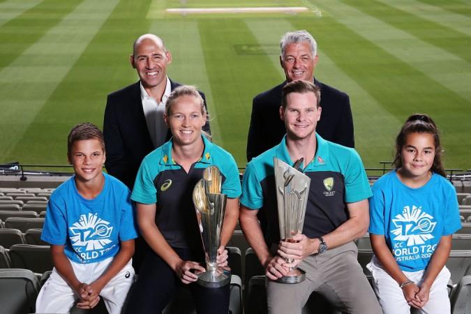 Nick Hockley, WT20 2020 LOC CEO, and David Richardson, ICC CEO, pose above Australian Cricket captains Meg Lanning and Steve Smith with the ICC T20 World Cup Trophies during the ICC World T20 media opportunity at on January 30, 2018 in Melbourne, Australia. ICC World T20 2020