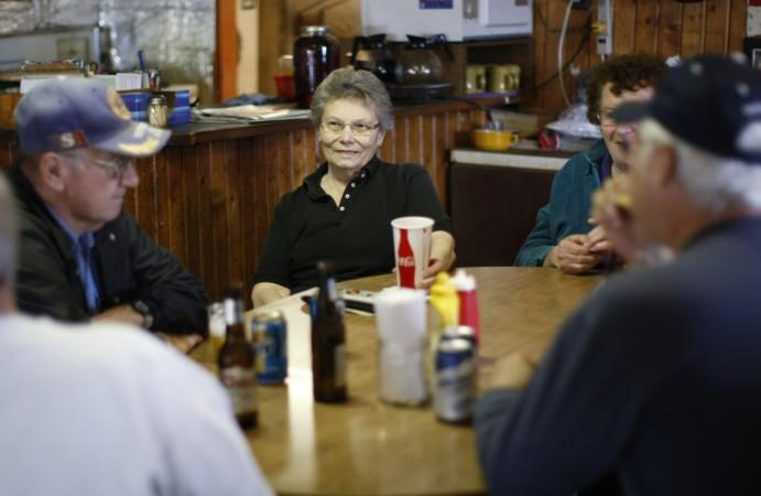 Elsie Eiler (C) talks with neighbors and friends in the tavern she runs in the village of Monowi, Nebraska Monowi