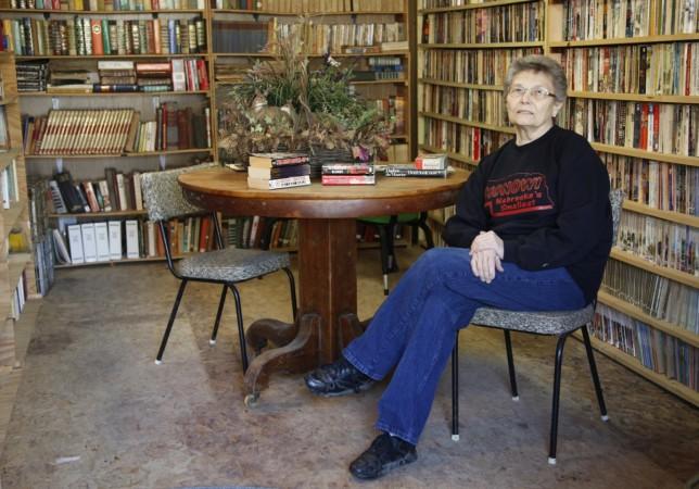 Elsie Eiler poses in the 5,000 book library in the village of Monowi, Nebraska Monowi