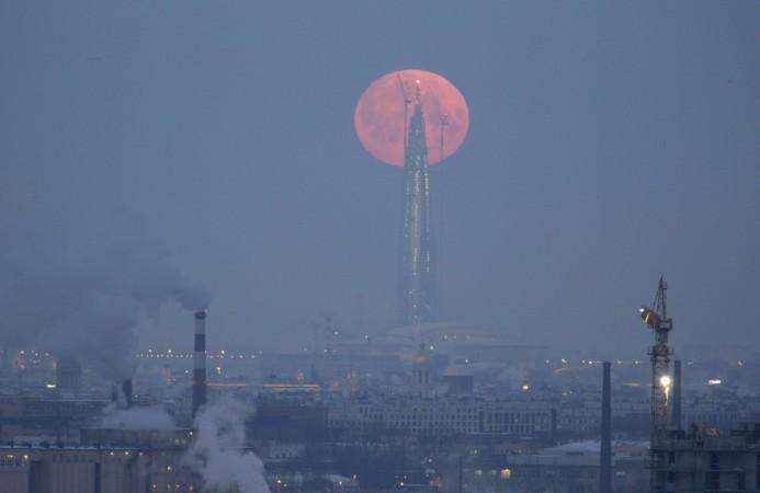 A full moon is seen behind the business tower Lakhta Centre, which is under construction in St. Petersburg, Russia January 31, 2018. Supermoon 2018 photos