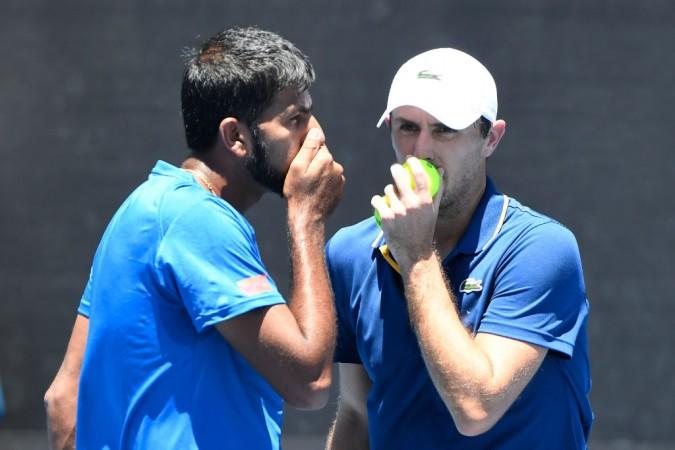 Rohan Bopanna of India (L) and Edouard Roger-Vasselin of France talk tactics in their first round men's doubles match against Ryan Harrison of the United States and Vasek Pospisil of Canada on day four of the 2018 Australian Open. Rohan Bopanna