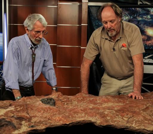 Ray Stanford and Martin Lockley are checking the massive slab of sandstone The massive slab of sandstone