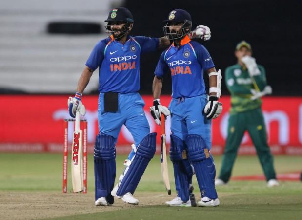 Virat Kohli (L) and Ajinkya Rahane celebrate the 100 partnership during the first One Day International (ODI) cricket match between South Africa and India at Kingsmead Cricket Ground on February 1, 2018 in Durban. Virat Kohli and Ajinkya Rahane