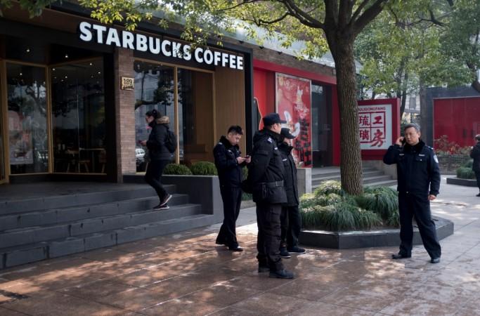 Police officers stand in front of a Starbucks in Shanghai on February 2, 2018 China accident