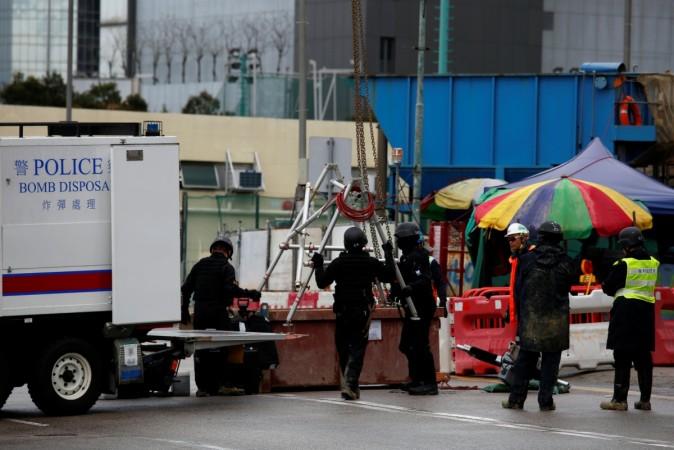 Members of the police bomb squad unload equipment where a World War Two bomb was found at a construction site in Hong Kong, China January 31, 2018. Members of the police bomb squad unload equipment where a World War Two bomb was found at a construction site in Hong Kong