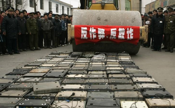 (File Photo) SHANGHAI, CHINA - MARCH 14: (CHINA OUT) Law enforcement officers and workers destroy 120 illegal electronic scales used to sell goods at a market on March 14, 2005 in Shanghai, China. Authorities have launched nationwide campaigns to promote better protection of consumer's rights and interests before the World Consumers' Rights Day. Fake and shoddy goods, weight and price fraud, insufficient product information and the monopolized sellers are some of the major problems known to consumers in China. The Chinese characters on the slogan reads: 'Object to cheat'. China Launches Nationwide Campaigns To Mark World Consumers' Rights Day