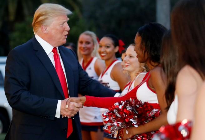 U.S. President Donald Trump greets cheerleaders with the Florida Atlantic University Marching Band before hosting a Super Bowl LII watch party. trump melania
