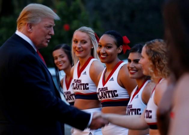 Trump shakes hand with the cheerleaders after their performance during the Super Bowl party. trump melania