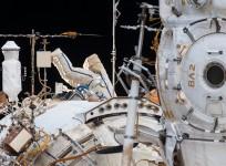 A Russian spacewalker is seen in an Orlan spacesuit with blue stripes (center image) working outside the Zvezda service module during the longest spacewalk in Russian space program history on Feb. 2, 2018.