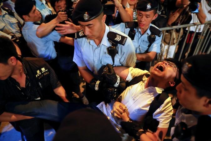 Student protest leader Joshua Wong shouts as he is carried by policemen. joshua wong