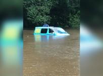 British backpackers wake up to find van partially submerged by floodwaters