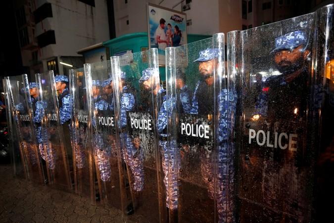 Maldivian police stand guard on a main street during a protest by opposition supporters against the government's delay in releasing their jailed leaders Maldives