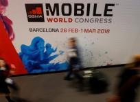 People walk past a hall at the Mobile World Congress in Barcelona, Spain