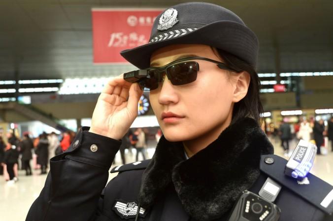 This photo taken on February 5, 2018 shows a police officer wearing a pair of smartglasses with a facial recognition system at Zhengzhou East Railway Station in Zhengzhou in China's central Henan province. Chinese police are sporting high-tech sunglasses that can spot suspects in a crowded train station, the newest use of facial recognition that has drawn concerns among human rights groups This photo taken on February 5, 2018 shows a police officer wearing a pair of smartglasses with a facial recognition system at Zhengzhou East Railway Station in Zhengzhou in China's central Henan province. Chinese police are sporting high-tech sunglasses