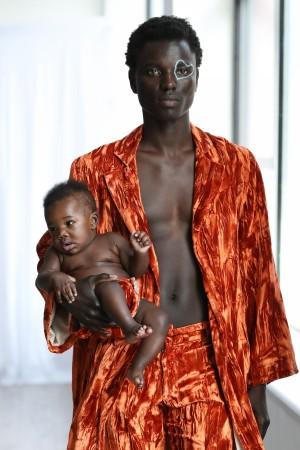 Model George Okeny walks the runway at the Collina Strada AW18 Collection with his son Zola during New York Fashion Week on February 8, 2018 in New York City. A model walks the runway at the Collina Strada AW18 Collection during New York Fashion Week on February 8, 2018 in New York City