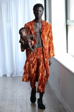Model George Okeny walks the runway at the Collina Strada AW18 Collection with his son Zola during New York Fashion Week on February 8, 2018 in New York City. Model George Okeny walks the runway at the Collina Strada AW18 Collection with his son Zola during New York Fashion Week 2018