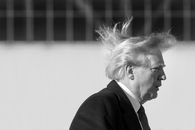 US President Donald Trump's hair blows in the wind as he boards Air Force One before flying to Vietnam Donald Trump