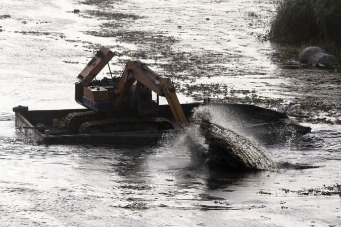 An excavator dredges the River Nile as part of a clean up operation in Cairo. Cairo