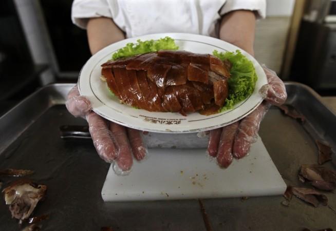 A chef presents the Peking Duck dish at a restaurant in Beijing. Peking duck