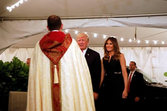 U.S. President Donald Trump and First Lady Melania Trump arrive for church service at the Church of Bethesda-By-The sea in Palm Beach, Florida, U.S., December 24, 2017. trump