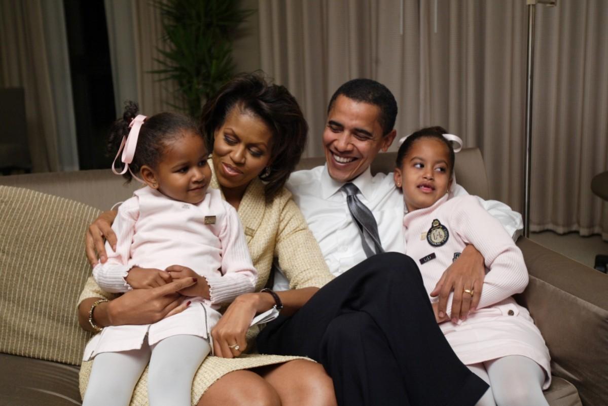 Barack Obama (2nd R), wife Michelle and their daughters Malia (R), 3, and Sasha (L), 6, spend time in their Chicago hotel room, November 2, 2004. Barack and Michelle Obama