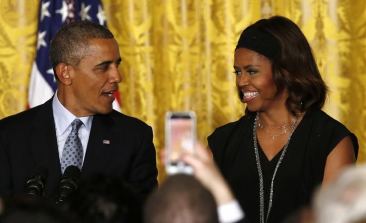 U.S. President Barack Obama and first lady Michelle Obama smile while hosting a reception to observe LGBT Pride Month at the White House in Washington June 30, 2014. Barack and Michelle Obama